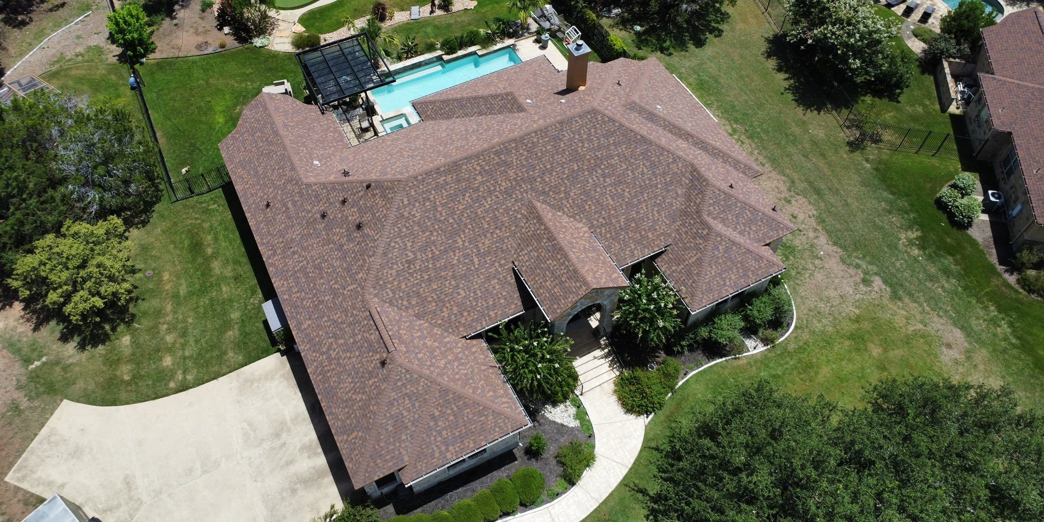 New Owens Corning Desert Rose roof installed in Driftwood, TX. Full storm restoration by Summit Roofing with expert insurance support.